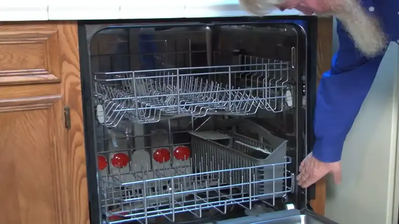 Dishwasher supply and drain hose connections inspected beneath a Commerce City kitchen cabinet
