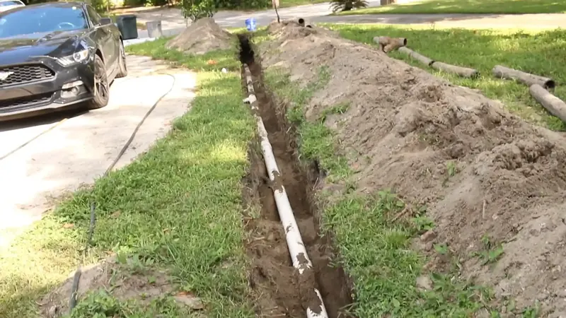 Sewer lateral cleanout in a Commerce City yard with inspection equipment staged nearby