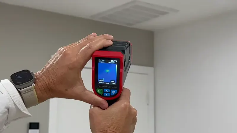 Thermal imaging camera display showing a warm zone on a Commerce City slab floor indicating a hot-water pipe leak
