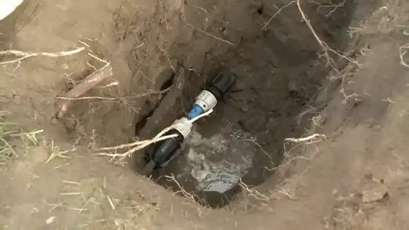 Excavated access trench exposing an underground supply pipe failure in a Commerce City Adams County yard