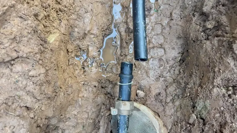 Soggy lawn area with surface saturation marking an active underground supply line leak in Commerce City Colorado